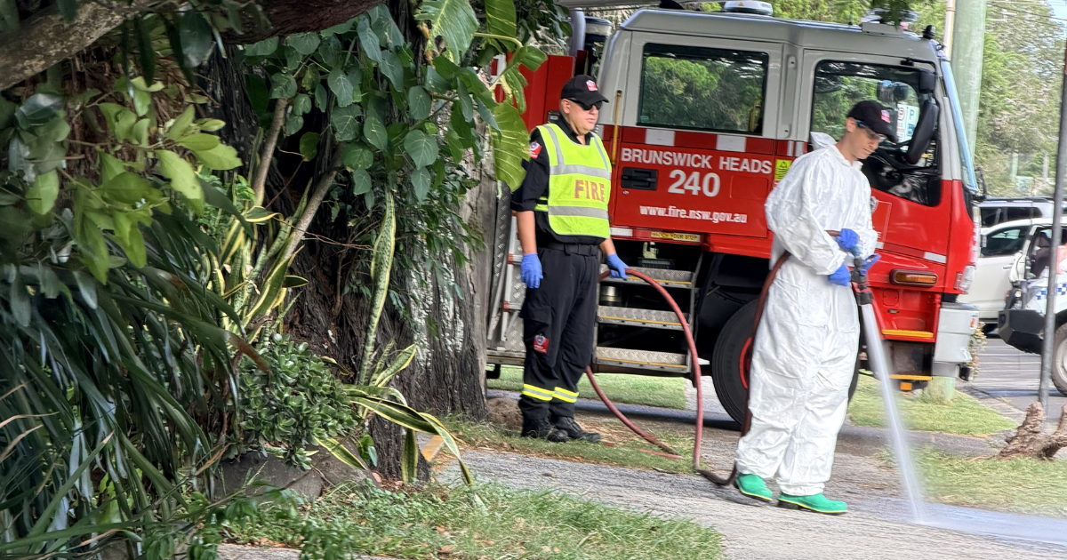 Emergency services wash down a Brunswick Heads street the day after a late-night incident. Photo: SUPPLIED