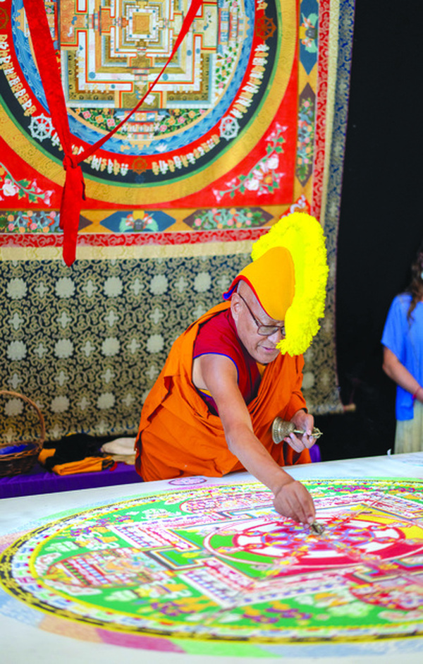 A Gyuto monk creating a sand mandala at Crystal Castle. Photo: Crystal Castle.