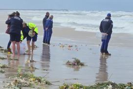 Volunteers and supporters walk along South Ballina Beach during a private ceremony honouring Frank Petsch and Bill Ewen. Photo: Marine Rescue NSW.
