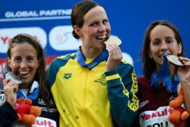 Tweed Heads swimmer Moesha Johnson on the podium after winning gold in the open water swimming women's 10km final at the World Aquatics Championships in Singapore. Photo: AAP