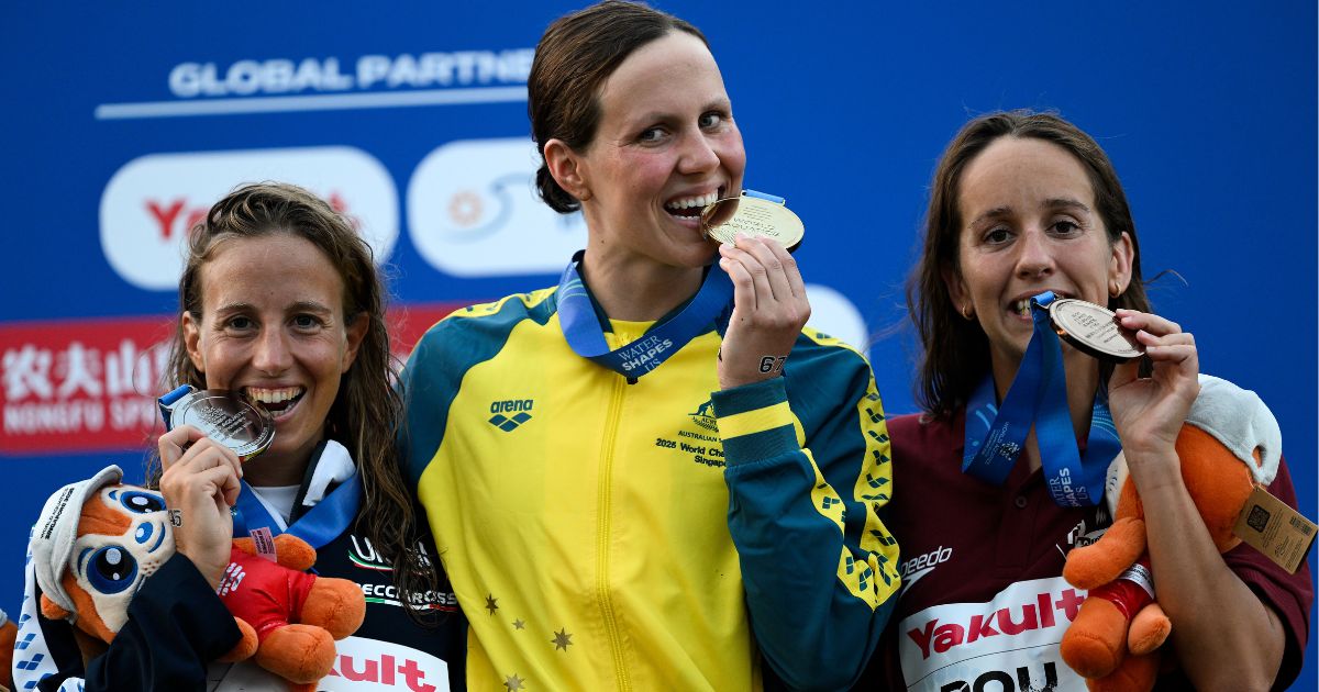 Tweed Heads swimmer Moesha Johnson on the podium after winning gold in the open water swimming women's 10km final at the World Aquatics Championships in Singapore. Photo: AAP