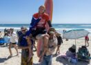 Byron Bay surfer Kai Ellice-Flint chaired up the beach after winning the men's longboard event at the Lexus US Open of Surfing at Huntington Beach, California. Photo: KENNY MORRIS/WSL