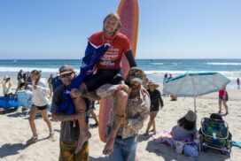 Byron Bay surfer Kai Ellice-Flint chaired up the beach after winning the men's longboard event at the Lexus US Open of Surfing at Huntington Beach, California. Photo: KENNY MORRIS/WSL