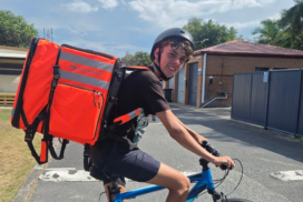 DoorDash delivery worker Zakia “Zak” Lovell rides his bike while completing deliveries. Photo: SUPPLIED